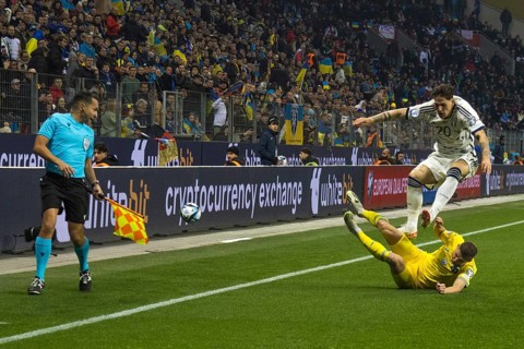 Vitaly MYKOLENKO Ukraine clears in front of Nicolo' ZANIOLO Italy in front of the linesman