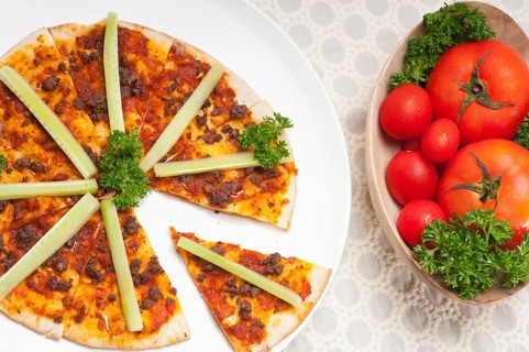 Fresh baked Turkish beef pizza with cucumber on top