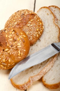 Fresh organic bread over rustic table macro closeup