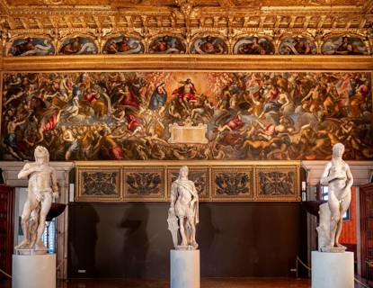 Sculptures in front of decorated wall