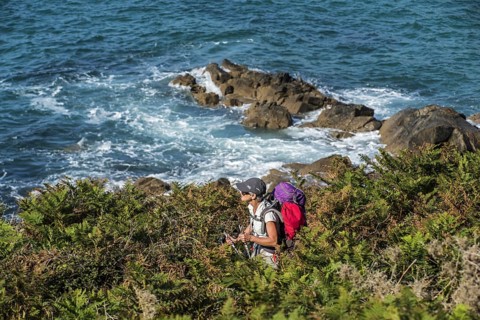 Elderly woman following the sentier des douaniers trail along the Brittany
