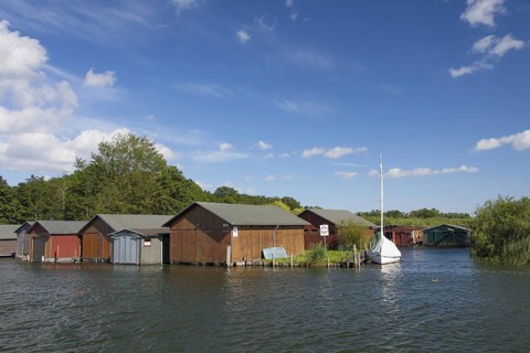 Wooden boat houses on the banks of the Plauer See at Plau am See