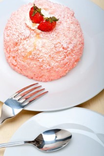 Fresh pink strawberry and whipped cream dessert macro close up