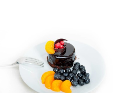Chocolate cake and fresh fruit on top closeup macro