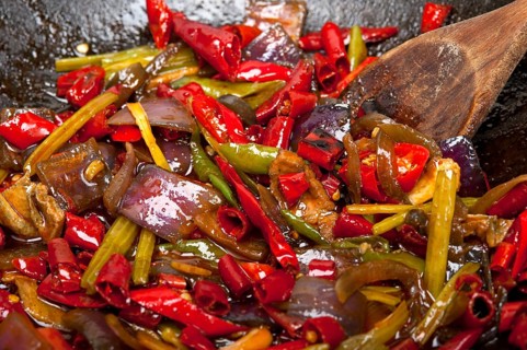 Fried chili pepper and vegetable on a iron wok pan
