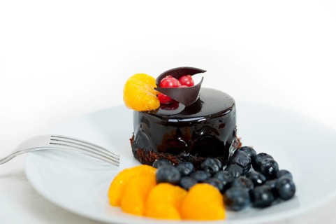 Chocolate cake and fresh fruit on top closeup macro
