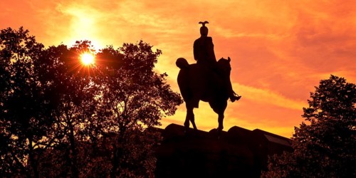 Equestrian statue of Kaiser Wilhelm II backlit at sunset