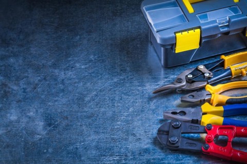 Copy space image of toolbox bolt cutter pliers and tin snips on scratched metallic surface construction concept