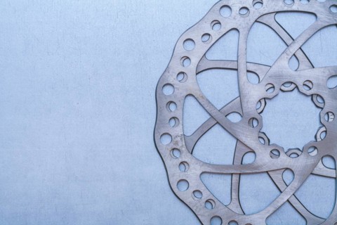 Metal gear wheel on flat metallic background Machine concept