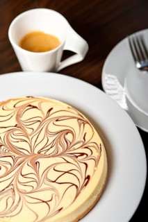 Fresh baked classic Cheese cake with chocolate topping and espresso coffee
