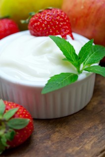 Fresh fruits and whole milk yogurt on a rustic wood table