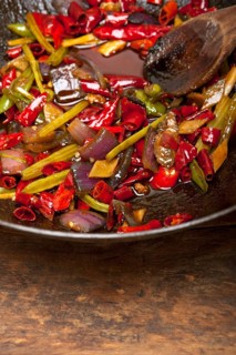Fried chili pepper and vegetable on a iron wok pan