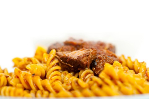 Fusilli pasta al dente with neapolitan style ragu meat sauce very different from bolognese style