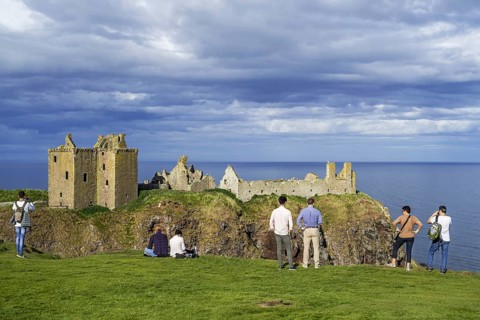 Tourists looking at Dunnottar Castle