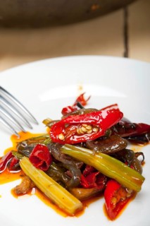 Fried chili pepper and vegetable on a iron wok pan