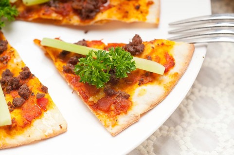Fresh baked Turkish beef pizza with cucumber on top