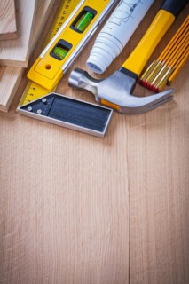 Collection of house-improvement working objects on wooden board copy space image construction concept
