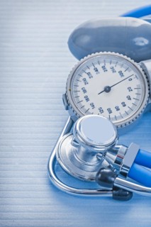Blood pressure monitor and stethoscope on a blue background