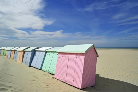 Row of colourful beach cabins in pastel colours along the North Sea at Berck