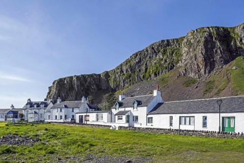 Row of white houses in former slate-mining village Ellenabeich on the isle of Seil