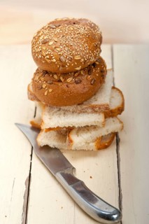 Fresh organic bread over rustic table macro closeup