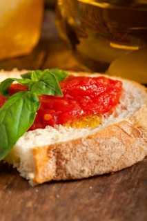 Italian fresh tomato and basil bruschetta with pecorino cheese over old wood