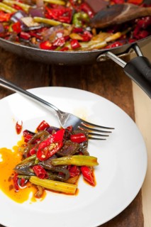 Fried chili pepper and vegetable on a iron wok pan