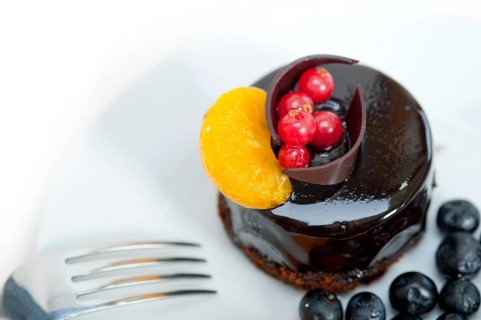 Chocolate cake and fresh fruit on top closeup macro