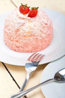 Fresh pink strawberry and whipped cream dessert macro close up