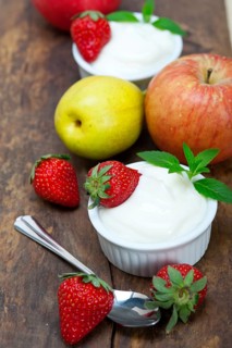 Fresh fruits and whole milk yogurt on a rustic wood table