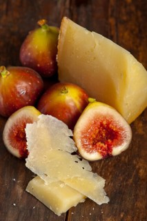 Italian pecorino cheese and fresh figs macro closeup over old wood boards