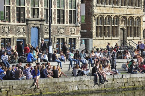 People enjoying the first spring sun by the waterside along the Graslei at Ghent