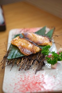 Japanese style teppanyaki roasted cod fish on palm leaf