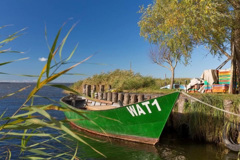 Fishing boat in small harbour of the Achterwasser at Warthe near Rankwitz on Usedom island in the Baltic Sea
