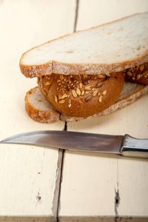 Fresh organic bread over rustic table macro closeup