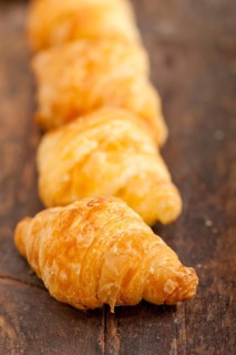 Fresh croissant french brioche over old wood table