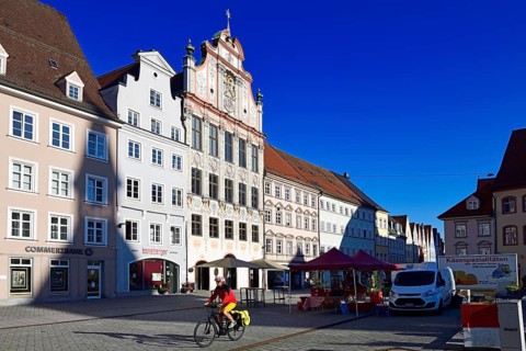 Cyclist in front of the market in the old town centre