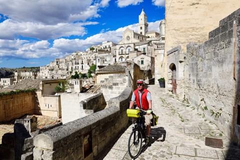 Cyclist with touring bike in the old town