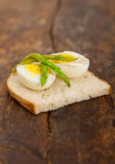 Boiled fresh green asparagus and eggs with extra virgin olive oil with rustic bread