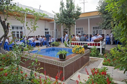 Family and friends gathered at wedding party at married couple's home in Samarkand
