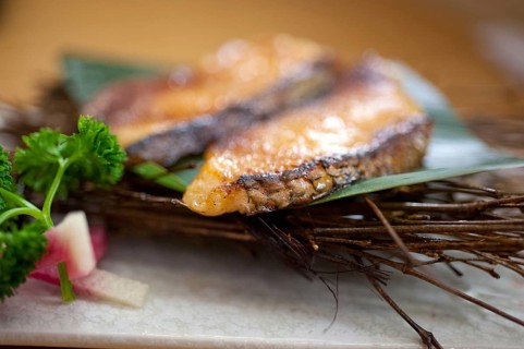 Japanese style teppanyaki roasted cod fish on palm leaf
