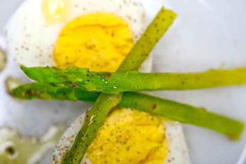 Boiled fresh green asparagus and eggs with extra virgin olive oil