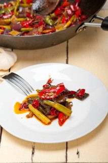 Fried chili pepper and vegetable on a iron wok pan