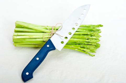 Fresh asparagus from the garden over white background with kitchen knife