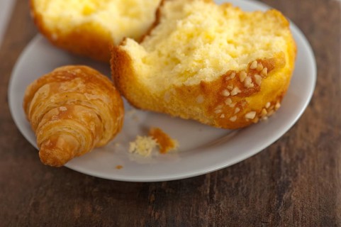 Fresh baked muffin and croissant mignon on old wood table