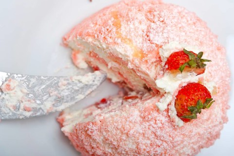 Fresh pink strawberry and whipped cream dessert macro close up