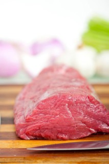 Raw beef and pork ribs with asparagus and herbs ready to cook