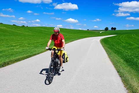 Cyclist on a picture-book country road near Berg