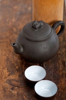 Chinese style pot and cups over old wood table