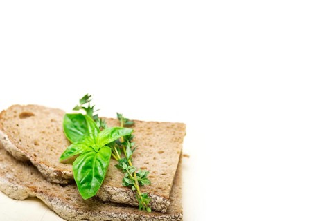 Rustic Italian bread basil and thyme simple snack on white wood table